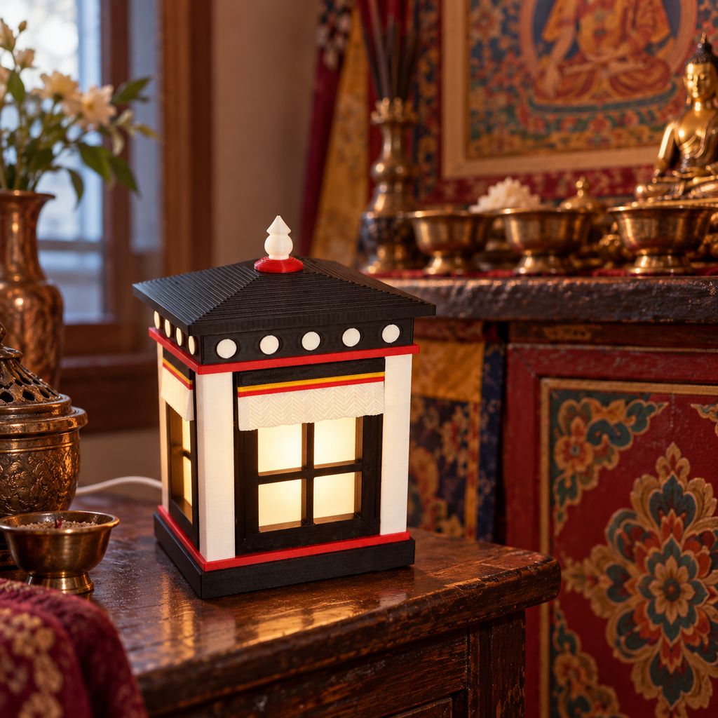 White pointed-top Tibetan Window Lamp beside a Tibetan home altar